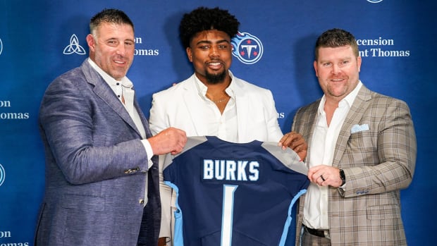 Tennessee Titans first round draft pick wide receiver Treylon Burks, center, holds up his jersey with head coach Mike Wrabel, left, and general manager Jon Robinson, right, during an introductory press conference at Saint Thomas Sports Park in Nashville, Tenn., Friday, April 29, 2022.